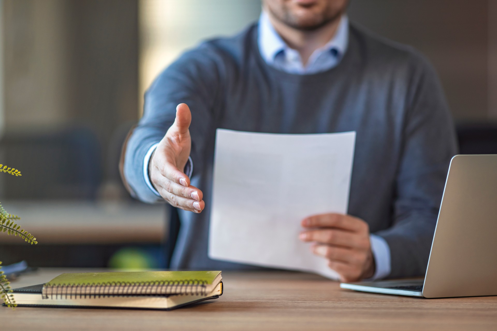 Businessman with an open hand ready for handshake